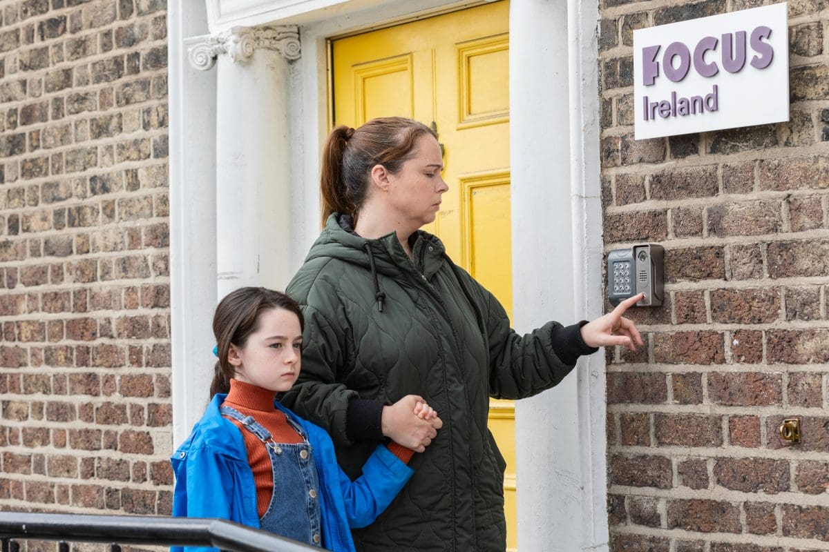 Mother and child at door of a homeless centre.